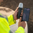 Closeup of surveyor using Emild Reach RX2 with their mobile phone