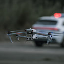 Autel EVO Max 4T hovering in the air in front of a police vehicle