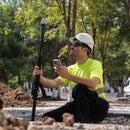 Emlid Reach RX being used by a surveyor in the field