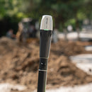 Emlid Reach RX2 on a survey pole at a construction site