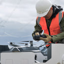 Inspection professional or utilities engineer configuring  DJI Dock 2 via a DJI RC Plus Controller for remote ops