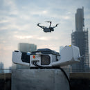 A DJI Matrice 4TD aircraft being deployed from a rooftop Dock 3 in a metropolitan area