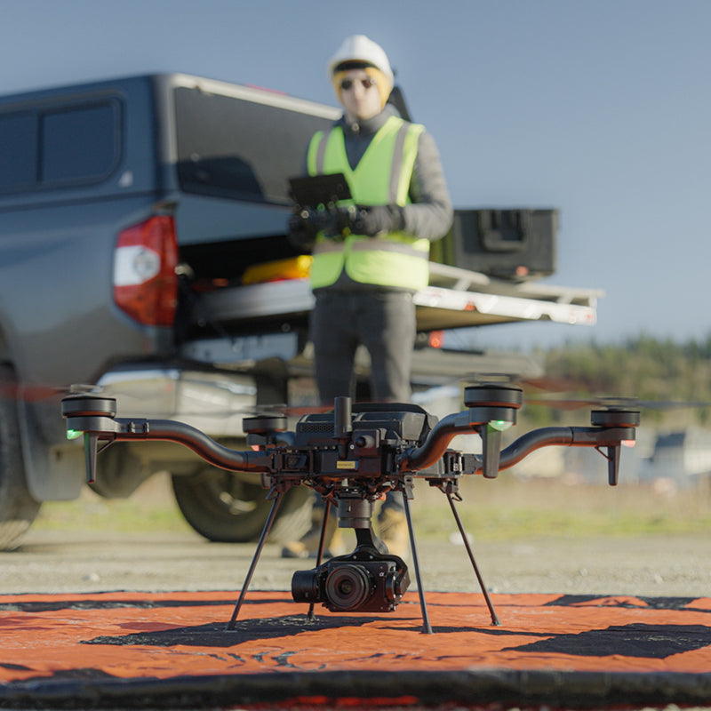 A drone pilot is piloting the Freefly Astro Max in the field