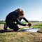 A female surveyor sets up WingtraGROUND on a Ground Control Point