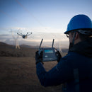 A powerline inspector piloting a DJI Matrice 4D Series drone using his DJI RC Plus 2 Enterprise Controller.jpg