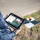 A surveyor configuring and setting up the WingtraGROUND receiver in a quarry