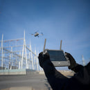 A utilities inspector flying a DJI Matrice 4 to inspect a power substation