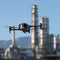 DJI Matrice 30T thermal drone being flown for critical infrastructure inspections, such as an oil refinery