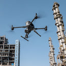 DJI Matrice 350 RTK drone with the Zenmuse H30T payload flying near an oil refinery