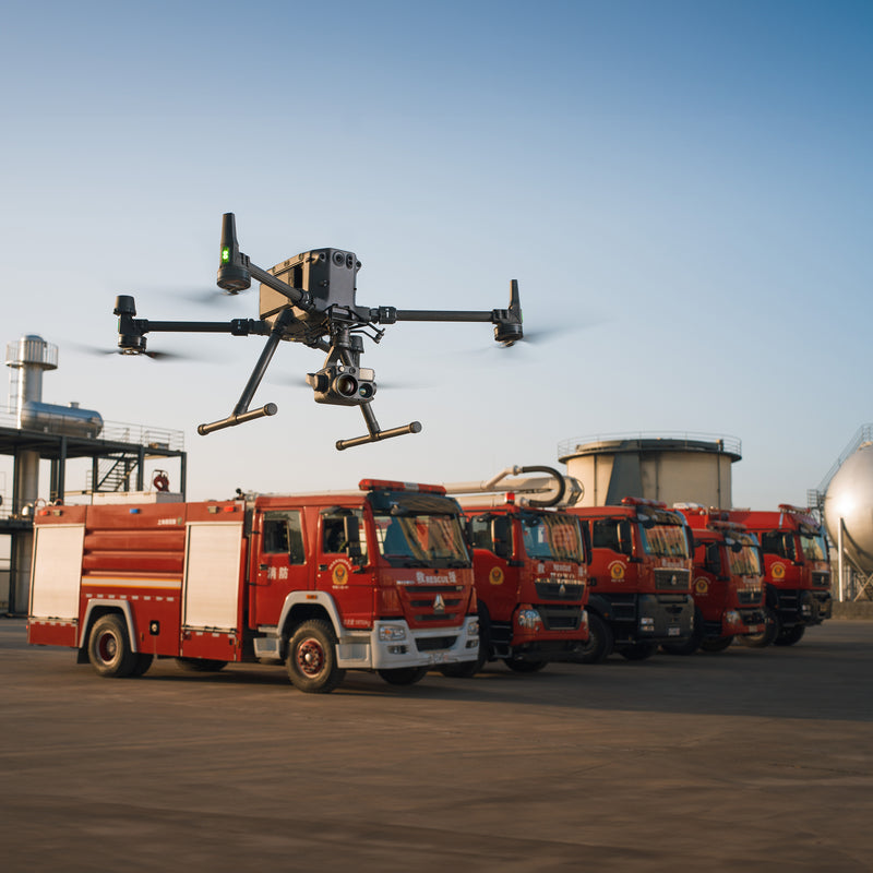 DJI Matrice 350 RTK drone with a Zenmuse H30T flying in front of fire trucks