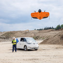 Drone pilot launchiing WingtraRAY fixed-wing drone to do volumetric measurements of aggregate stockpiles