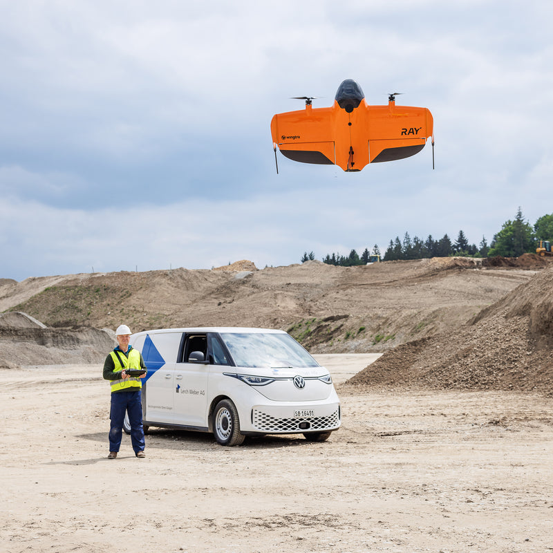 Drone pilot launchiing WingtraRAY fixed-wing drone to do volumetric measurements of aggregate stockpiles