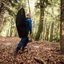 Drone pilot walking through a forested area with the WingtraRAY strapped to his back