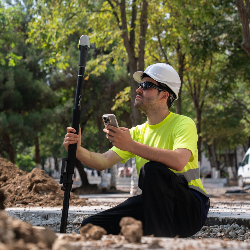 Emlid Reach RX being used by a surveyor in the field
